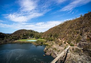 bridge overlooking a gorge with a swimming pool