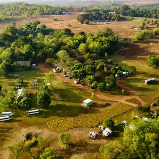 aerial shot of caravans dotting the verdant greenery at Litchfield Tourist Park in Darwin