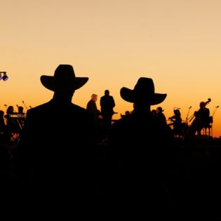 silouettes of crowd and performers at Festival of Outback Opera Singing In The Night event 2024