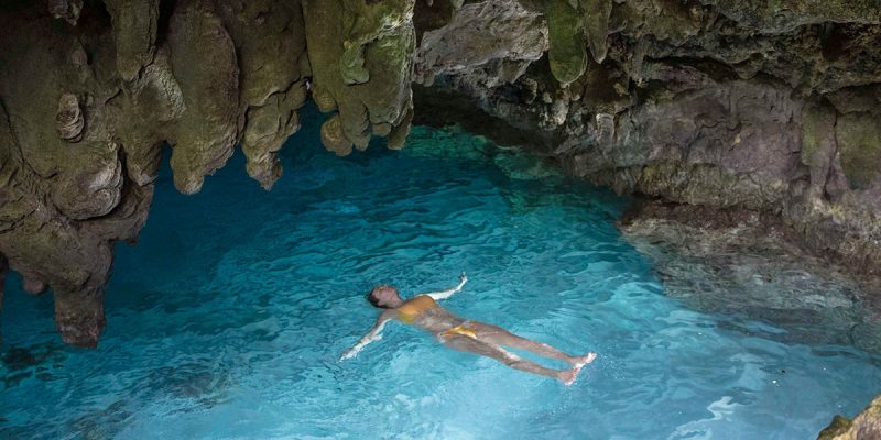 Woman swimming in a grotto on Christmas Island