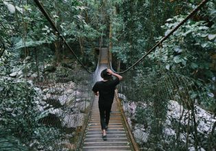 a woman enjoying the scenic walk by the Minnamurra Rainforest Centre in Budderoo National Park