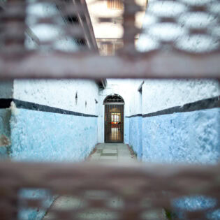 peeking through a small hole in the corridor of Fremantle Prison