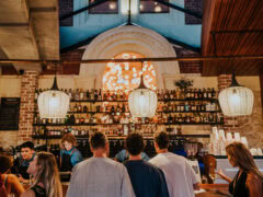 people lining up at the well-lit bar counter of Mr Chapple, Fremantle