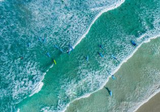 Aerial shot of surfers at Redgate Beach in Margaret River. (Image: Tourism Western Australia)
