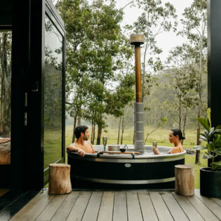 a couple relaxing in the outdoor tub at Billy’s Hideaway, Hunter valley