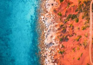 an aerial view of the sandstone cliffs of Gantheaume Point, Broome fringed by the Indian Ocean