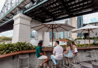 friends dining at Fiume Bar with views of the Story Bridge