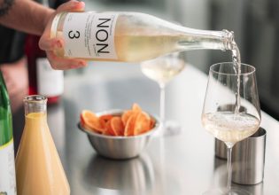 pouring NON 3 drink into a glass