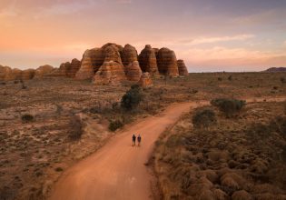 two people walking toward The Bungle Bungle Range, Purnululu National Park