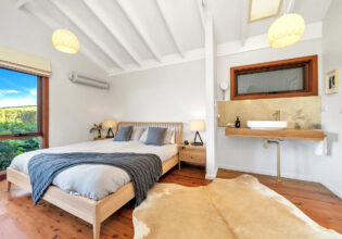 a cosy bedroom at Saddleback Grove, Kiama
