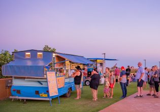 people lining up outside a food stall at Town Beach Night Markets, Broome