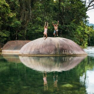 Couple jump off the Babinda Boulders near Cairns