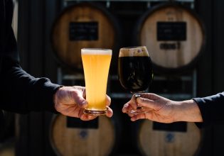 two people clinking their glasses filled with cold brew