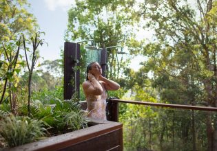 Gwinganna Lifestyle Retreat woman in outdoor shower
