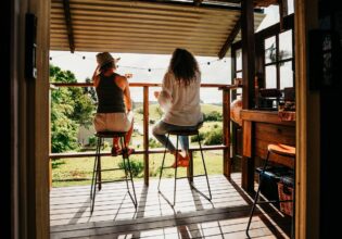 Couple on the deck at Hazy Stays in Byron Bay