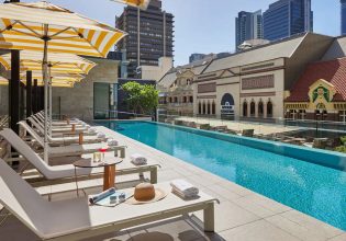 A swimming pool surrounded by the city.
