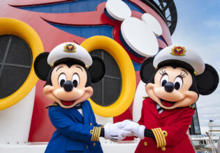 Captains Mickey Mouse and Minnie Mouse at funnel of Disney Wonder cruise ship