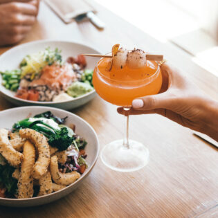 Couple enjoying a feast at Moku Bar & Grill in Cairns
