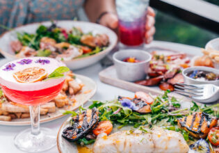 Two women drink cocktails and dine at Oak and Vine Restaurant and Bar in Cairns