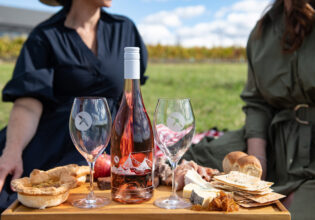 Two women enjoying a platter while on Printhie Helicopter Ultimate Winery Tour