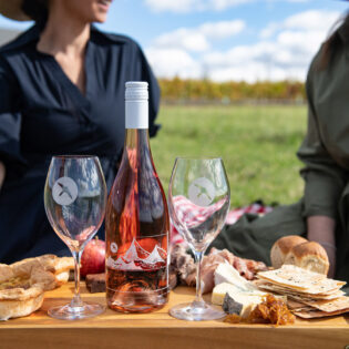 Two women enjoying a platter while on Printhie Helicopter Ultimate Winery Tour