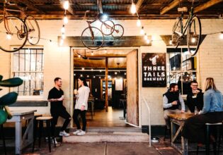 Patrons enjoying a drink at Three Tails Brewery