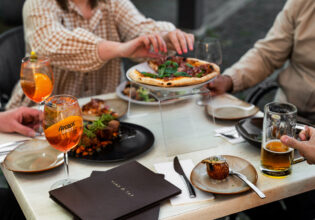 a group of people eating pizza with Aperol spritz at Vine & Tap Wine Bar, Bathurst