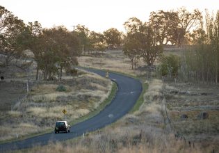 Car driving through the New England countryside in Uralla.